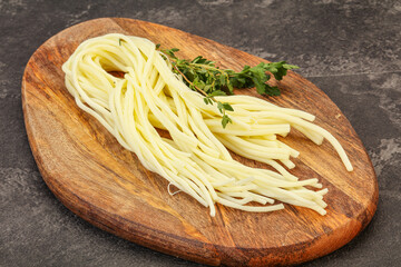 Chechil spaghetti cheese over board