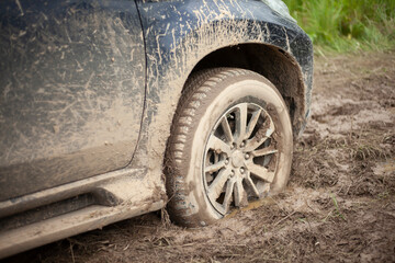 The wheels of the car are stuck in the mud. Off-road driving.