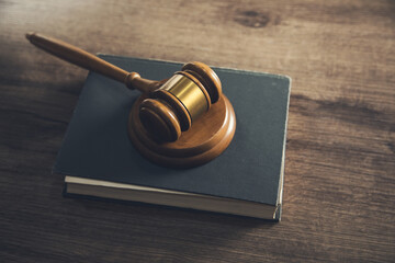 Wooden judges gavel lying on a book