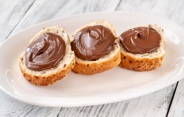 Slices of baguette with chocolate paste