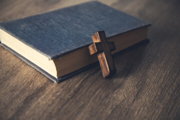 wooden cross on the Bible