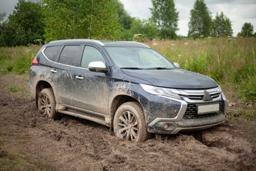 The wheels of the car are stuck in the mud. Off-road driving.