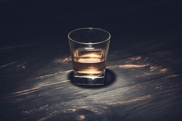 whiskey with ice on a wooden table