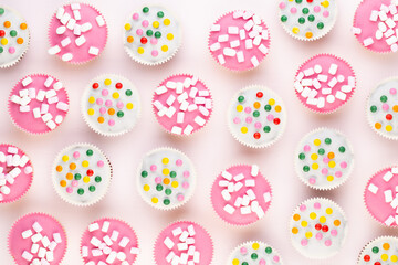 Colorful cupcakes on a white background.