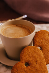 Cozy winter or autumn morning at home. Hot coffee, cookies warm blanket and garland, Swedish hygge concept.
