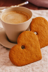 Cozy winter or autumn morning at home. Hot coffee, cookies warm blanket and garland, Swedish hygge concept.