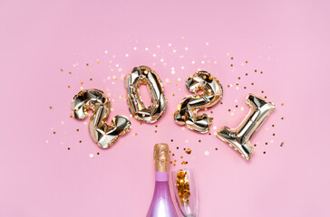 2021 golden foil balloons numbers, champagne, stars confetti, ribbons  and bokeh. Top horizontal...