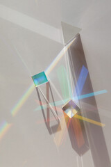 Glass geometric figures prisms with light diffraction of spectrum colors and complex reflection...