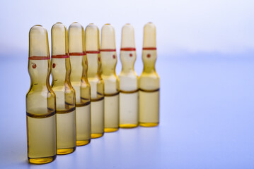 glass medicine ampoules with liquid in blue light