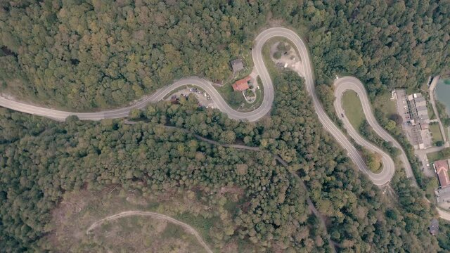 Passroad at a Mountain. Turns through forest. Aerial Birdview. Kesselberg next to Walchensee. Bavaria