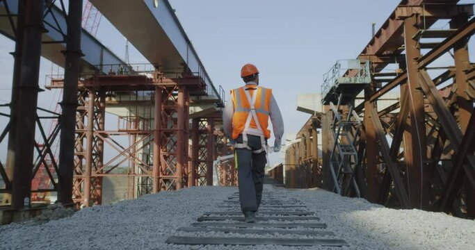 Unrecognizable builder walking on construction site