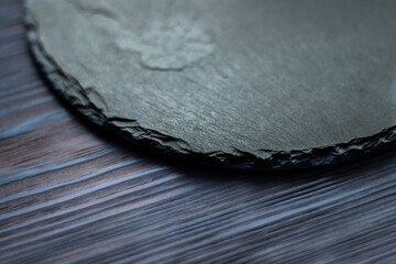 round black slate board on wooden table