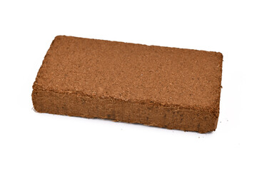 Natural coconut fibre soil pressed into brick shape isolated on white background