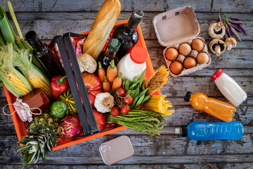 Shopping basket filled with foods from supermarket - obrazy, fototapety, plakaty