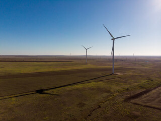 windmills work in a summer field