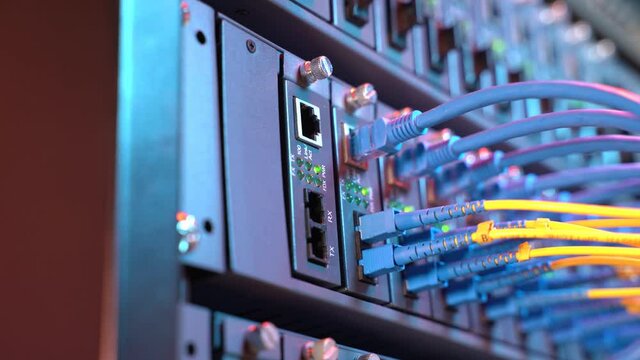 Fiber Optic cables connected to optic ports and UTP, Network cables connected to ethernet ports.