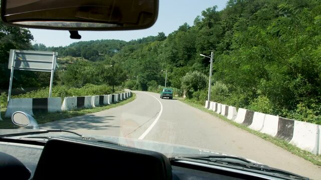 Car pursuing a lada in a georgian countryside