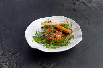 salmon tartare, white bread toast in a plate