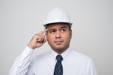 Young asian civil engineer helmet hard hat standing and thinking on isolated white background. Mechanic service concept..