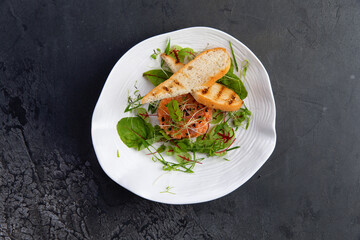 salmon tartare, white bread toast in a plate