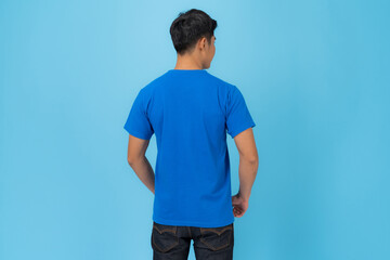 Young man in blue t-shirt isolated on blue background