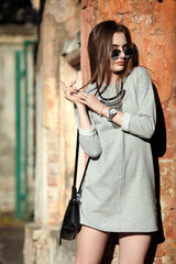 Close up of black leather bag handbag in hands of stylish women. Fashionable girl on the street. Female fashion concept. City lifestyle
