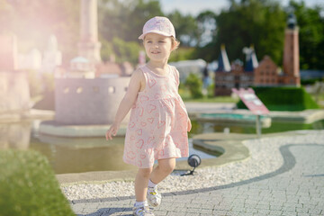 Little girl spending fantastic time on playground. Happy childhood. Authentic image.