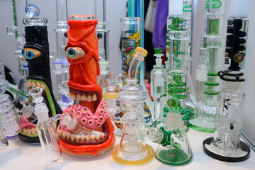 Made of glass bongs for cannabis smoking placed on a counter of a shop
