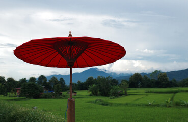 focus on vintage red umbrella decorated in the local coffee shop at Nan province, Thailand