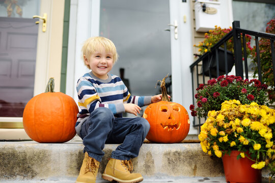 Little Child Sitting On Porch Of His Home And Waiting For The Traditional 