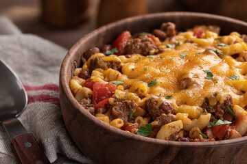 Bowl of chili mac with cheddar cheese