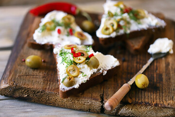 Open sandwiches with mascarpone cheese, olives and herbs. Healthy food. Keto snack.