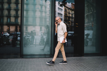 Cheerful senior man talking on smartphone