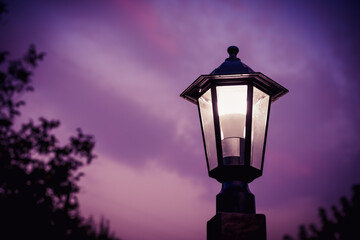 Fototapeta na wymiar Glowing street lamp against the background of the evening sky
