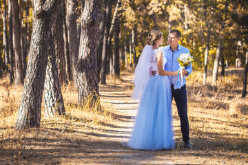 happy bride and groom are walking in the green Pine forest