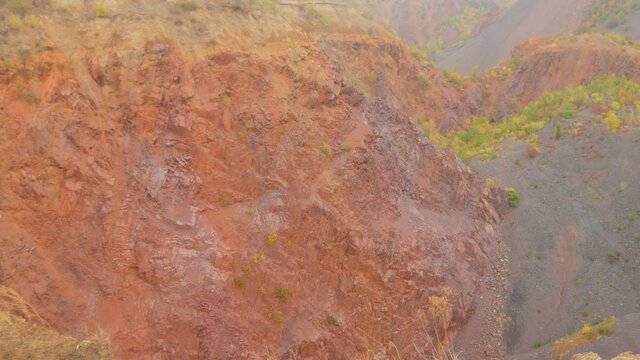 Failed quarry iron ore mine, mine construction. Industrial mining conveyor red iron ore Krivoy Rog Ukraine.