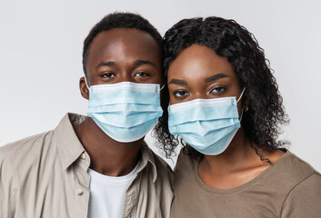 Portrait of young african american couple wearing protective masks