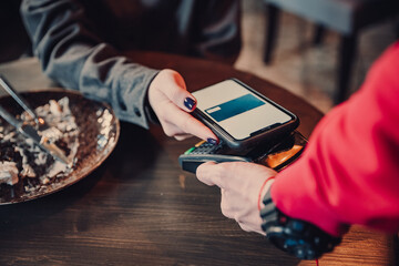 Contactless mobile payment. Mobile payment in cafe with smart phone nfc near field communication wireless technology