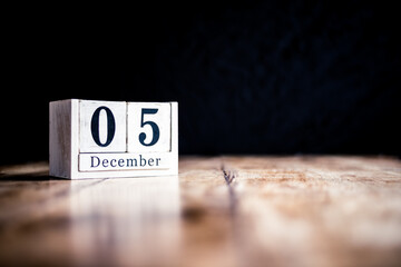 December 5th, 5 December, Fifth of December - White block calendar on vintage table - Date on dark background