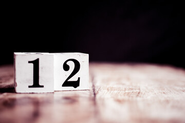 Number 12 isolated on dark background- 3D number twelve isolated on vintage wooden table