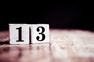 Number 13 isolated on dark background- 3D number thirteen isolated on vintage wooden table