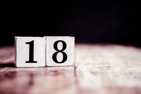 Number 18 isolated on dark background- 3D number eightteen isolated on vintage wooden table