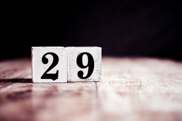 Number 29 isolated on dark background- 3D number twenty nine isolated on vintage wooden table