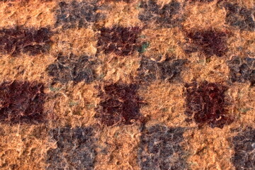 textured background with details of an old checkered blanket