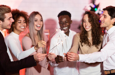 Millennial Friends Celebraing Christmas Burning Sparklers Standing Indoors