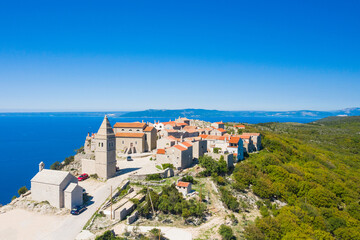 Amazing historical town of Lubenice on the high cliff, Cres island in Croatia, Adriatic sea in background
