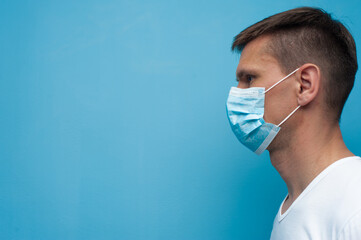 Side portrait of young woman wearing a medical mask