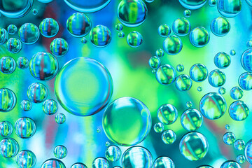 Oil drops on a water surface - abstract macro in blue and green
