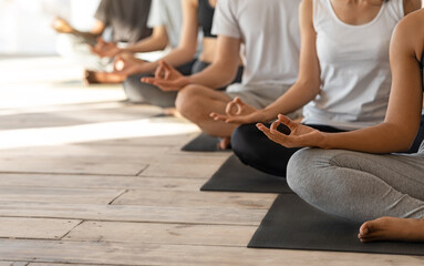 Unrecognizable Group Of People Practicing Yoga In Studio, Meditating In Lotus Position