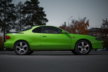 Fototapeta premium Green and black sport coupe car with big wheels. Japanese oldtimer.
